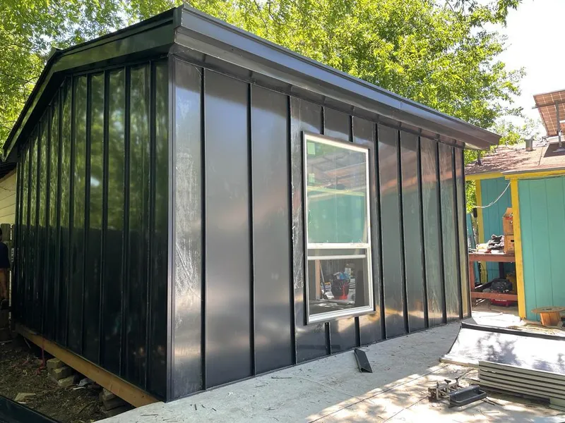 Black standing seam metal wall panels for Metal Roof Installation in Spirit Lake