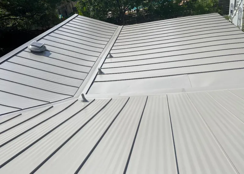 Solar attic fan installed on a metal roof for Roof Ventilation in Spirit Lake